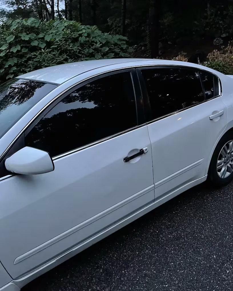 White sedan with tinted side windows by Clean Tint