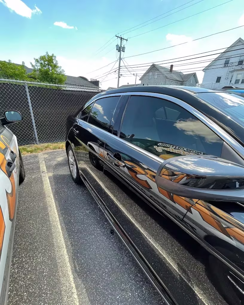 Black sedan side profile with tinted glass by Clean Tint